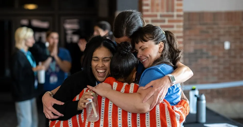 Breathe for Change educators hugging at a training